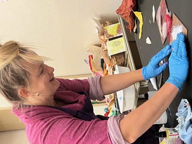 Photo of Amanda Rose Hopkins working on artwork