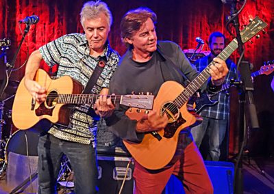 Photo of Musicians Lorin and Chris Rowand onstage with guitars